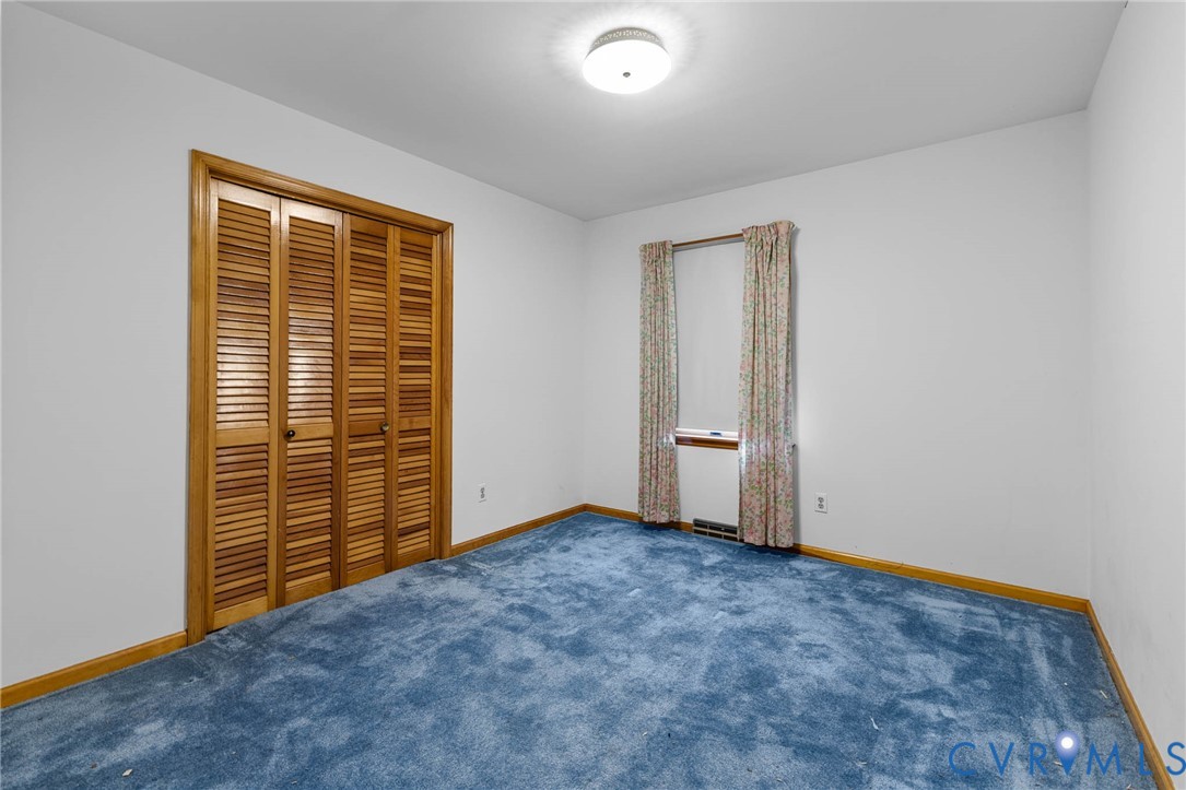 24925 Smith Grove Road Petersburg, VA 23803 - Photo 17 of 19 Unfurnished bedroom with carpet floors and a close