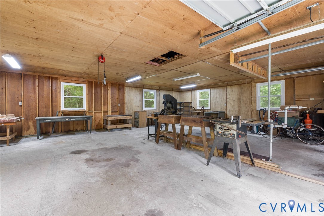24925 Smith Grove Road Petersburg, VA 23803 - Photo 19 of 19 Garage with a workshop area and wooden walls