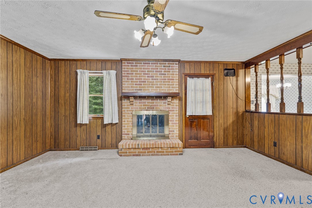 24925 Smith Grove Road Petersburg, VA 23803 - Photo 4 of 19 Unfurnished living room with carpet floors, wooden
