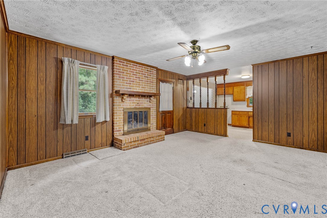 24925 Smith Grove Road Petersburg, VA 23803 - Photo 5 of 19 Unfurnished living room featuring wood walls, ligh