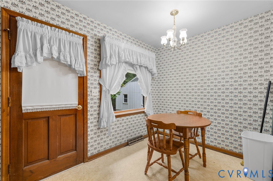 24925 Smith Grove Road Petersburg, VA 23803 - Photo 9 of 19 Carpeted dining room with a chandelier and wallpap