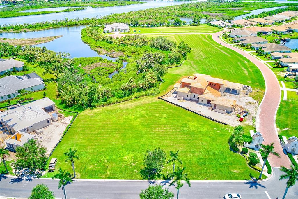 an aerial view of a house with a garden and lake view