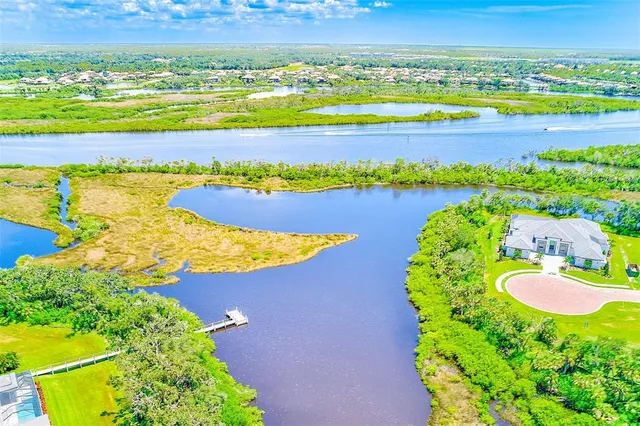 an aerial view of residential houses with outdoor space and swimming pool