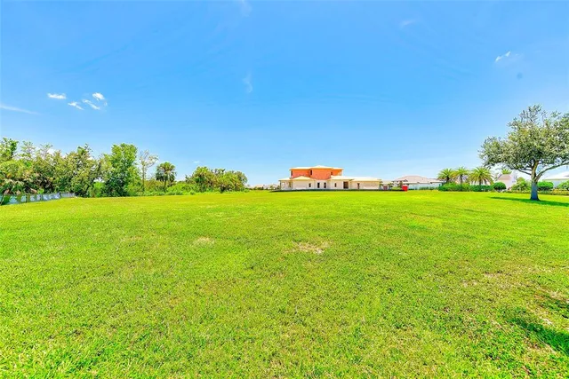 a view of a green field with sitting area