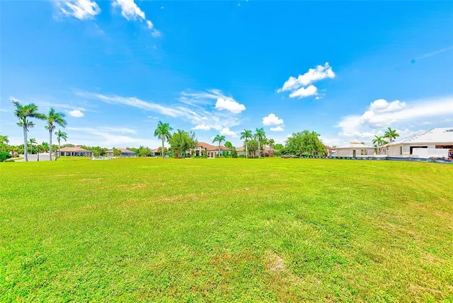 a view of a big yard with a house in the background