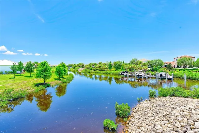 a view of a lake with houses in the back