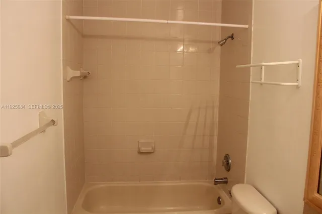a bathroom with a shower and a toilet