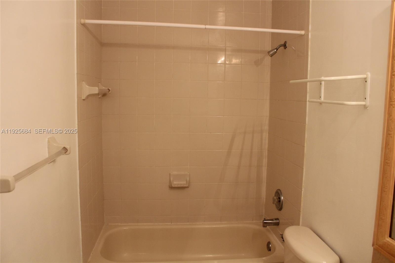 3433 Southwest 171st Terrace, Unit 3433 Miramar, FL 33027 - Photo 14 of 22 a bathroom with a shower and a toilet