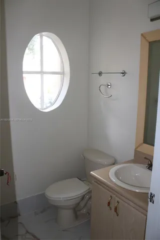 a white toilet sitting next to a window
