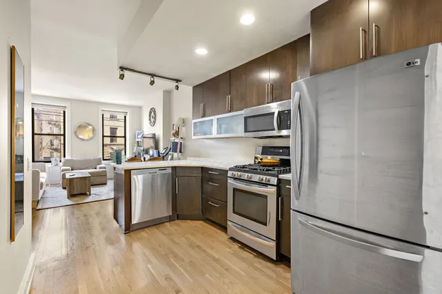 a kitchen with granite countertop stainless steel appliances and wooden cabinets