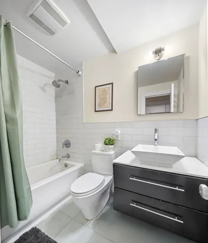 a bathroom with a sink a toilet and a bathtub