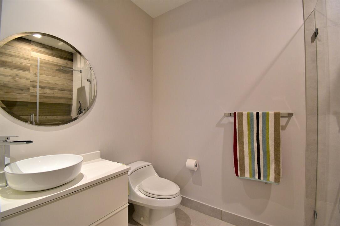 4866 Northwest 16th Avenue Boca Raton, FL 33431 - Photo 11 of 67 a bathroom with a toilet and a mirror