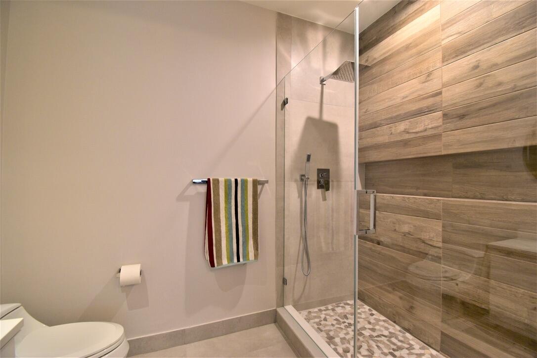 4866 Northwest 16th Avenue Boca Raton, FL 33431 - Photo 12 of 67 a bathroom with a toilet and a shower