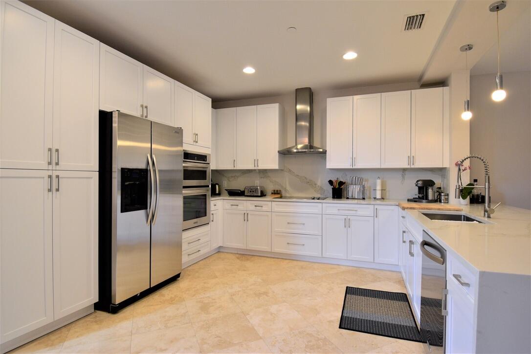 4866 Northwest 16th Avenue Boca Raton, FL 33431 - Photo 17 of 67 a kitchen with a refrigerator stove top oven and sink