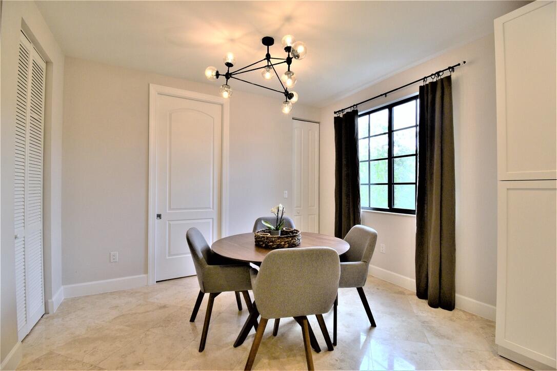 4866 Northwest 16th Avenue Boca Raton, FL 33431 - Photo 20 of 67 a dining room with furniture window and wooden floor