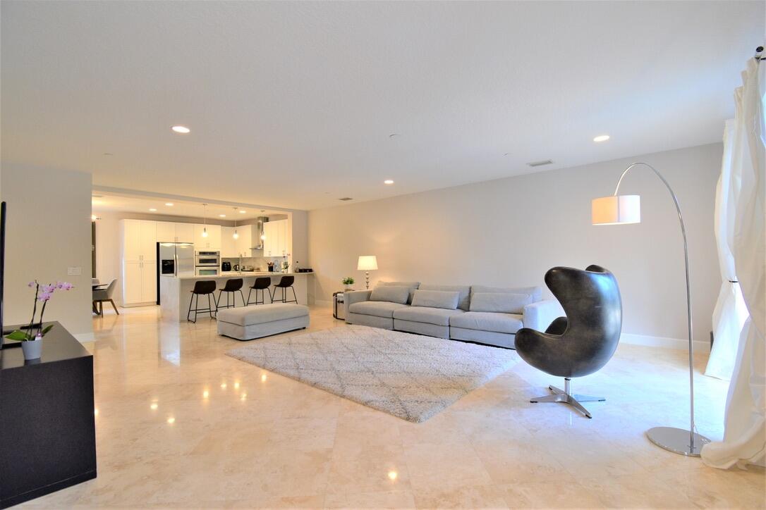 4866 Northwest 16th Avenue Boca Raton, FL 33431 - Photo 23 of 67 a living room with furniture and a large window