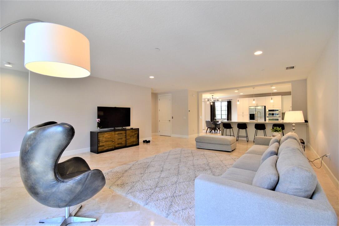 4866 Northwest 16th Avenue Boca Raton, FL 33431 - Photo 24 of 67 a living room with furniture and a flat screen tv