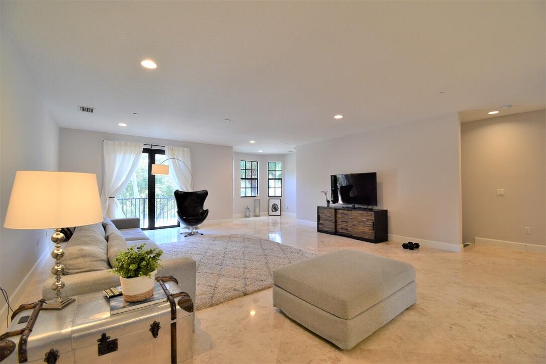 4866 Northwest 16th Avenue Boca Raton, FL 33431 - Photo 25 of 67 a living room with furniture and a flat screen tv