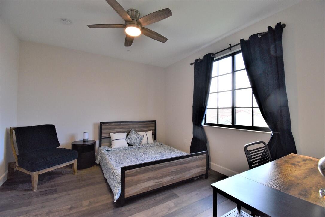 4866 Northwest 16th Avenue Boca Raton, FL 33431 - Photo 29 of 67 a bedroom with a bed window and a desk
