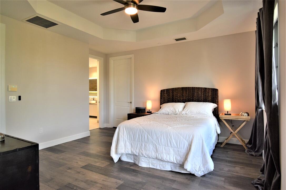 4866 Northwest 16th Avenue Boca Raton, FL 33431 - Photo 38 of 67 a bedroom with a bed and a ceiling fan