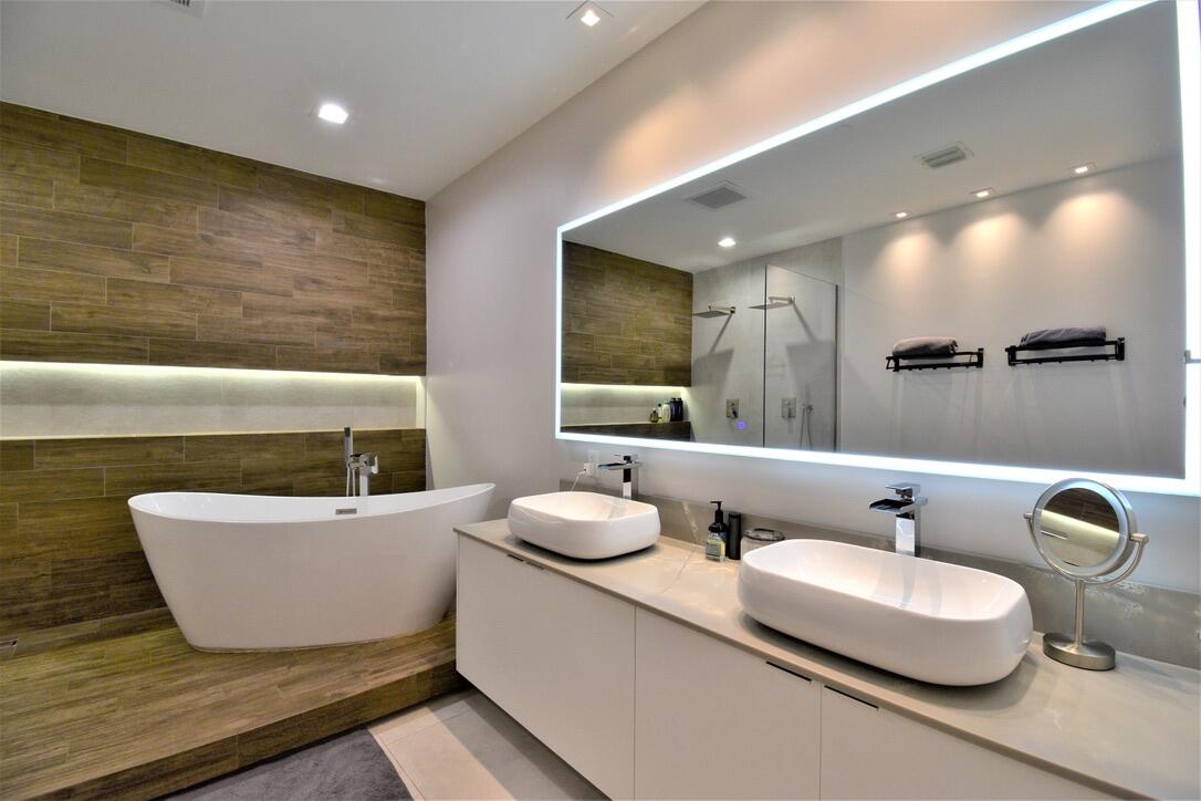4866 Northwest 16th Avenue Boca Raton, FL 33431 - Photo 40 of 67 a bathroom with a double vanity sink and a mirror