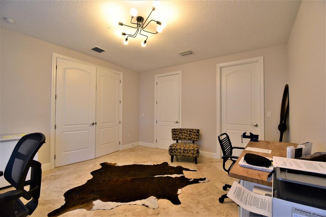 4866 Northwest 16th Avenue Boca Raton, FL 33431 - Photo 9 of 67 a view of a workspace with furniture and gym equipment