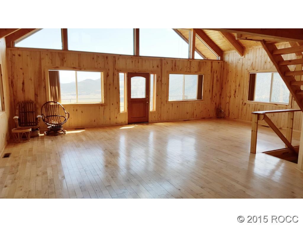52989 County Road Villa Grove, CO 81155 - Photo 4 of 24 a open hall with a bench and wooden floor
