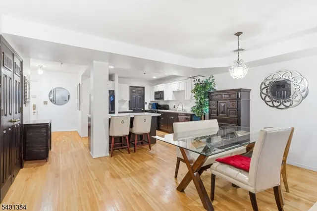 a living room with dining room and kitchen view