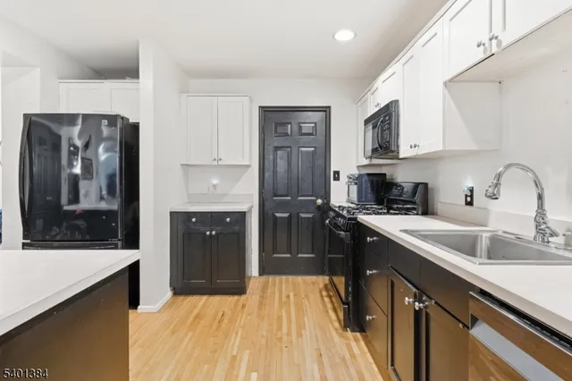 a kitchen with stainless steel appliances granite countertop a refrigerator stove and sink