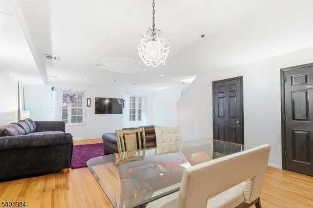 a living room with furniture and a chandelier