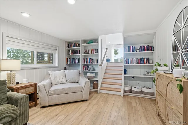 a living room with furniture and a book shelf