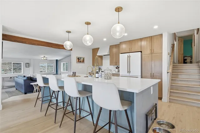 a large kitchen with a table and chairs