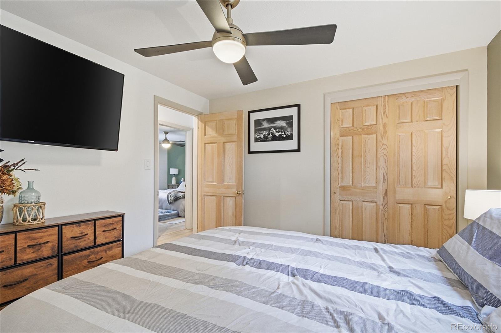 6387 High Drive Morrison, CO 80465 - Photo 24 of 49 a bedroom with a bed and a flat screen tv