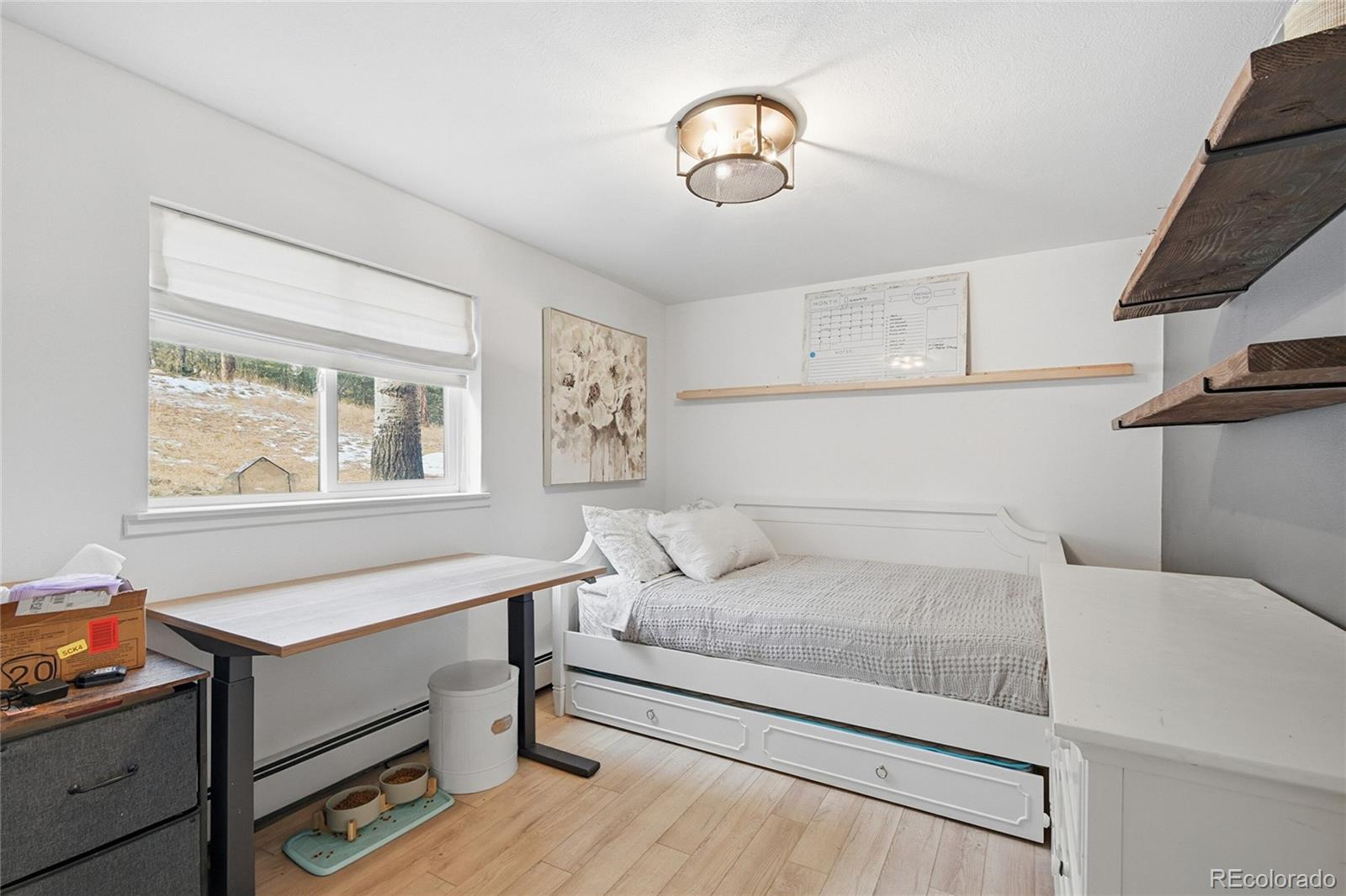 6387 High Drive Morrison, CO 80465 - Photo 26 of 49 a bedroom with a bed and a chandelier