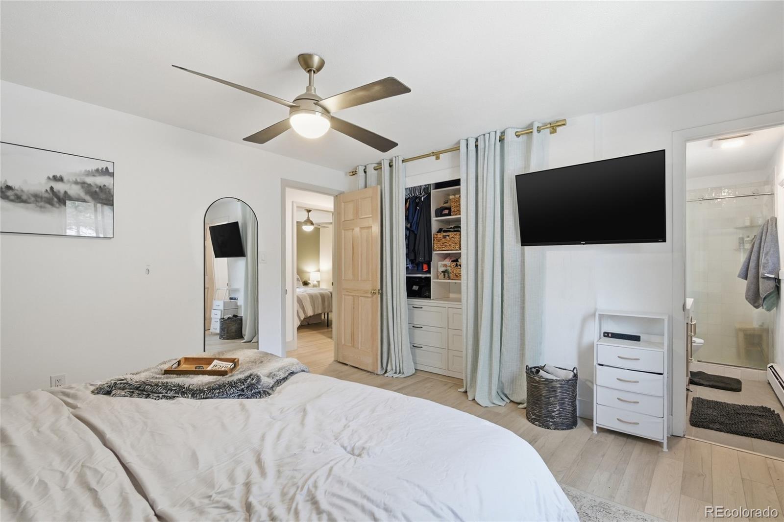 6387 High Drive Morrison, CO 80465 - Photo 27 of 49 a bedroom with a bed and a flat screen tv