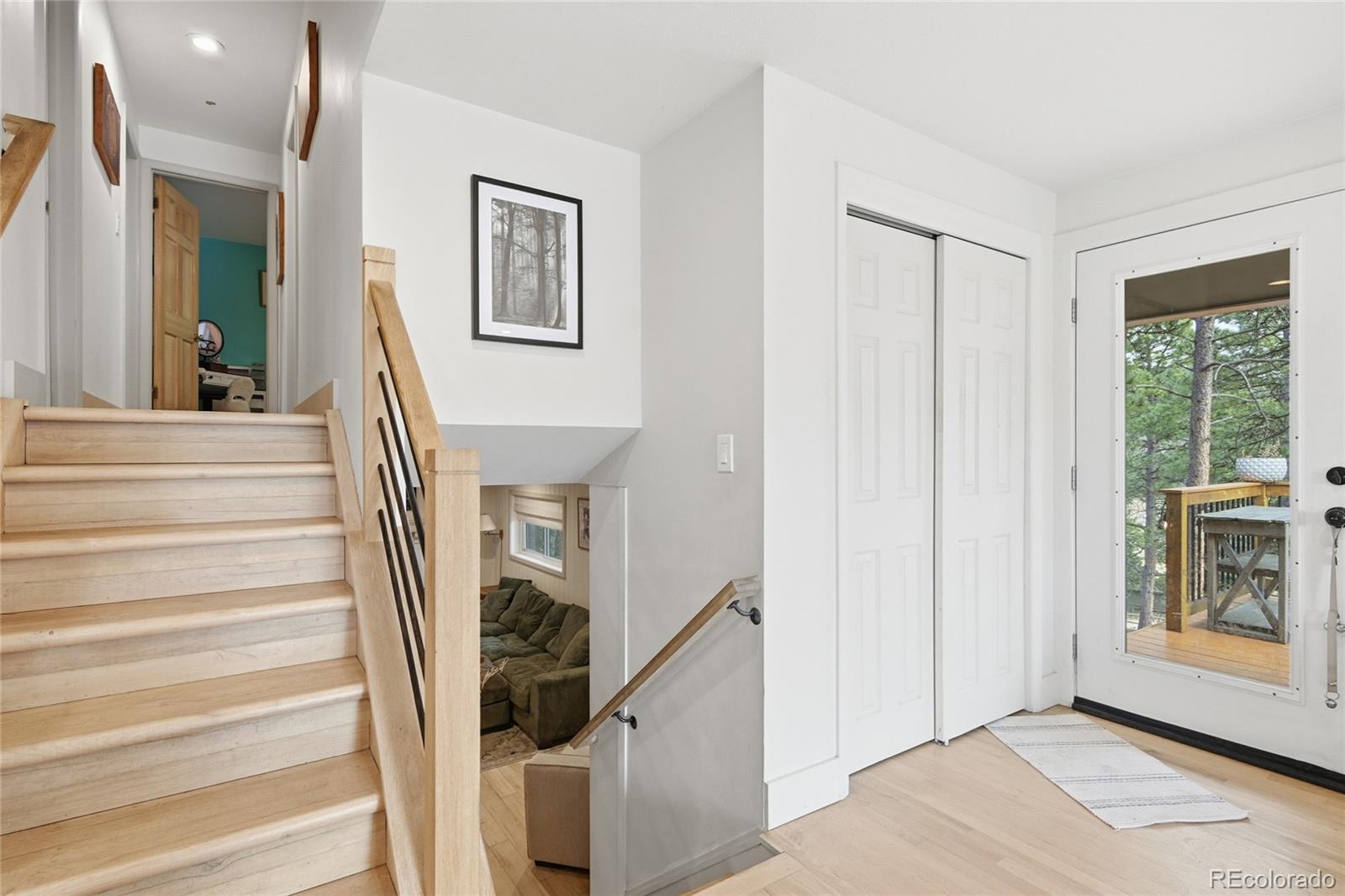 6387 High Drive Morrison, CO 80465 - Photo 30 of 49 a view of a hallway with wooden floor and staircase