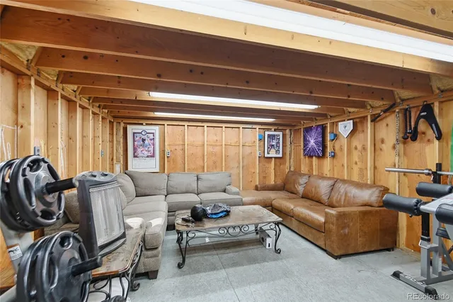 a living room with furniture a couch and a window