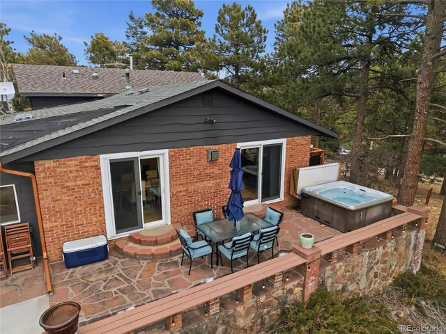 a backyard of a house with table and chairs