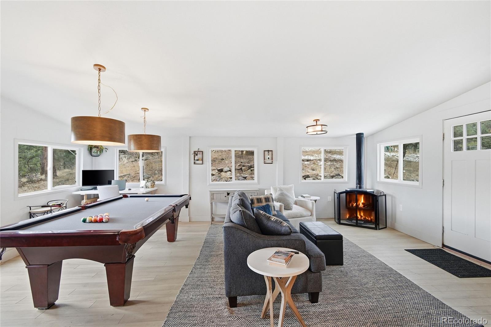 6387 High Drive Morrison, CO 80465 - Photo 5 of 49 a living room with furniture a table and a fireplace