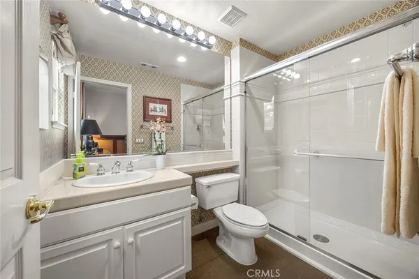 a bathroom with a sink toilet and shower
