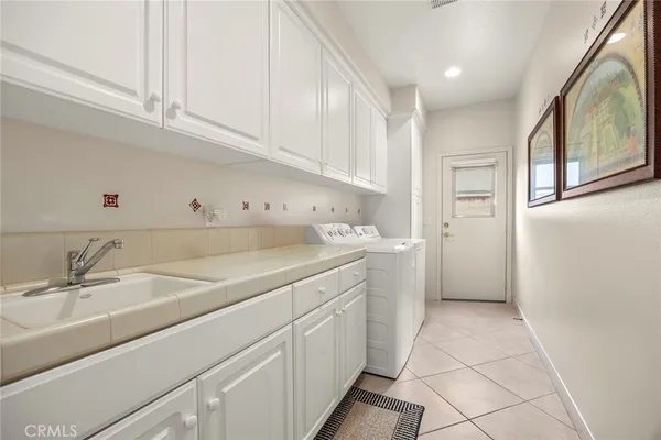 a kitchen with a sink cabinets and window