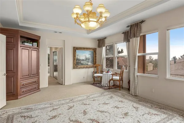a very nice looking room with a large window and chandelier
