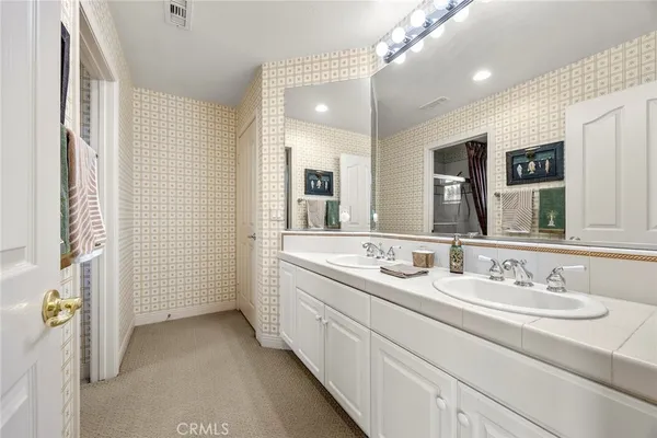 a bathroom with 2 sink and a mirror