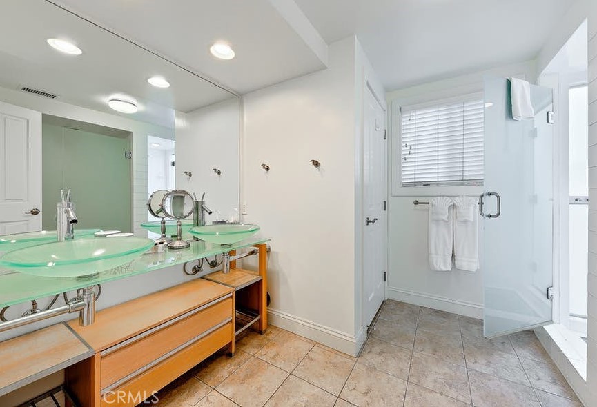 35087 Beach Road Dana Point, CA 92624 - Photo 13 of 25 a bathroom with a double vanity sink and a mirror