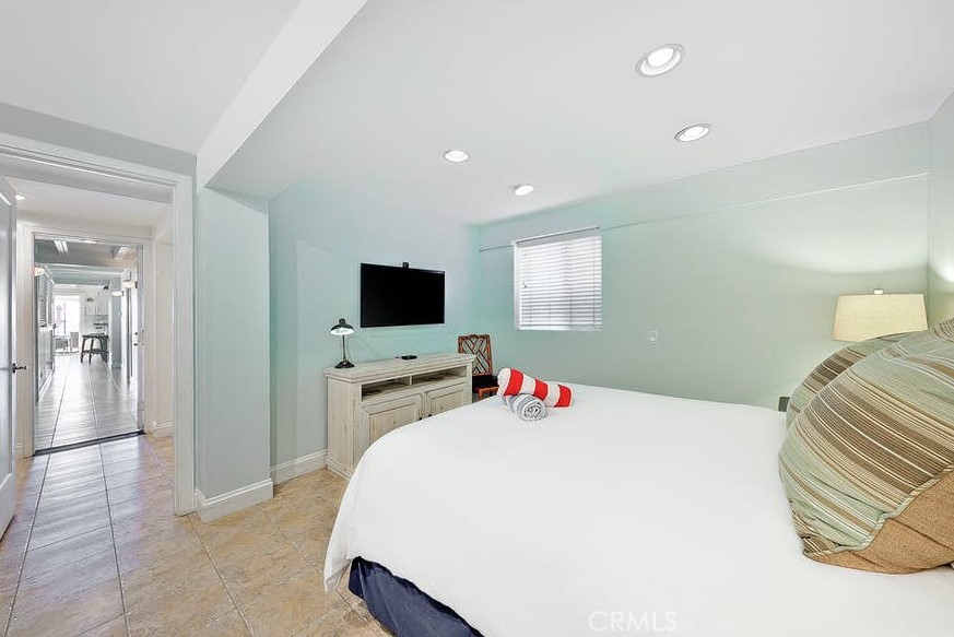35087 Beach Road Dana Point, CA 92624 - Photo 14 of 25 a bedroom with a bed and a flat screen tv