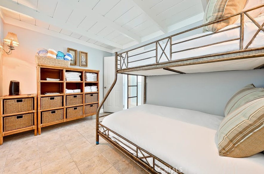 35087 Beach Road Dana Point, CA 92624 - Photo 15 of 25 a bed room with a bed and a book shelf