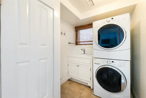 a dining room with furniture and a large window