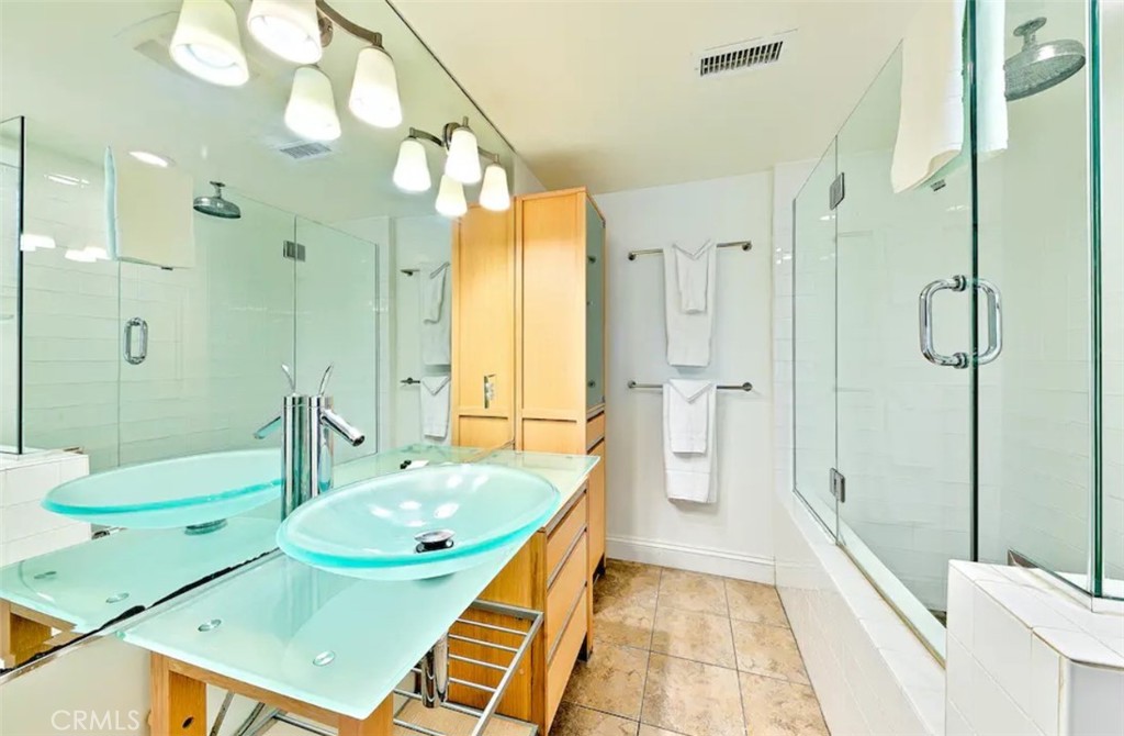 35087 Beach Road Dana Point, CA 92624 - Photo 19 of 25 a bathroom with a tub a sink and a large mirror