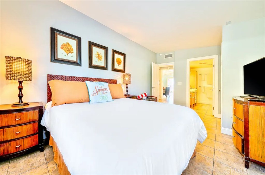 35087 Beach Road Dana Point, CA 92624 - Photo 21 of 25 a bedroom with a bed and lamps