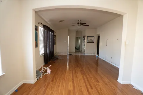 a view of a hallway with wooden floor and closet